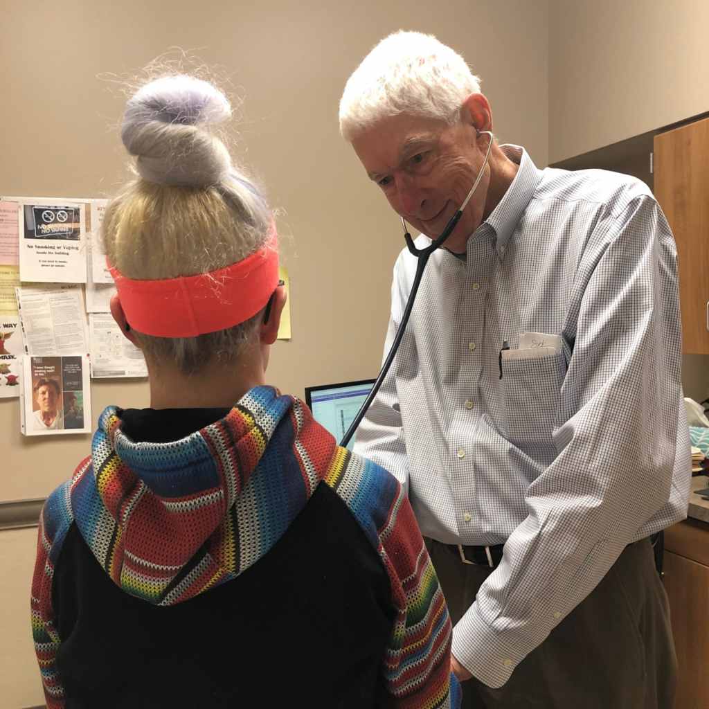 Health professional with stethoscope checking a patient