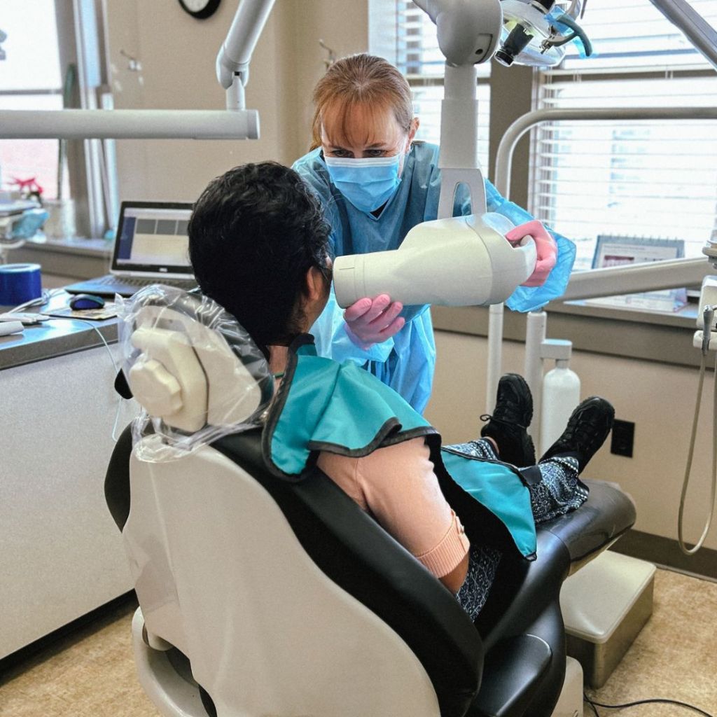 Dental professional taking an x-ray scan on a patient